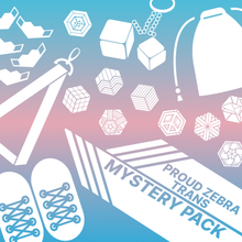 Load image into Gallery viewer, Trans flag overlapped with proud zebra product icons with words trans mystery pack. Used for proud zebra's website product listing of pride mystery boxes.