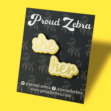 Load image into Gallery viewer, She/her matte gold and white pronoun pins on black backing card by proud zebra