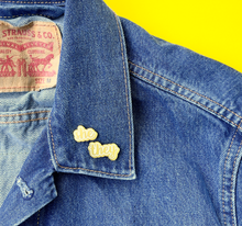 Load image into Gallery viewer, She/They matte gold and white pronoun pins on jean jacket by proud zebra