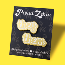 Load image into Gallery viewer, They/Them matte gold and white pronoun pins on black backing card by proud zebra