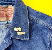 Load image into Gallery viewer, They/Them matte gold and white pronoun pins on jean jacket by proud zebra