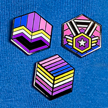 Load image into Gallery viewer, Person wearing a blue t-shirt with colorful geometric designs on a dark background
